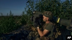 A Ukrainian serviceman prepares an anti-tank rocket launcher aiming towards Russian positions at the front line close to Donetsk, Ukraine, Aug. 19, 2023. 