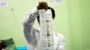 FILE - An official of the Union Election Commission counts ballots at a polling station in Naypyitaw, Myanmar, Nov. 8, 2020. A top election official was fatally shot, April 22, 2023, in his car in Yangon, in the latest attack attributed to militants opposed to military rule. 