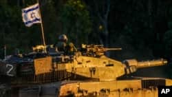 An Israeli tank moves along the Israel-Gaza border as seen from southern Israel, Jan. 4, 2024.