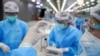 FILE - A medical worker prepares a syringe with a dose of China's Sinovac coronavirus vaccine at the Central Vaccination Center, inside the Bang Sue Grand Station, in Bangkok, Thailand, May 24, 2021.