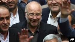 FILE - Mohammad Qalibaf, center, is surrounded by lawmakers after being elected as speaker of the parliament, in Tehran, Iran, May 28, 2020. Qalibaf registered his candidacy June 3, 2024, for the country’s June 28 presidential election.