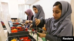 Members of Afghan robotics girls team which was denied entry into the United States for a competition, work on their robots in Herat province, Afghanistan July 4, 2017. 