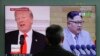 FILE - A man watches a TV screen showing file footages of U.S. President Donald Trump (L) and North Korean leader Kim Jong Un (R) during a news program at the Seoul Railway Station in Seoul, South Korea, March 27, 2018. 
