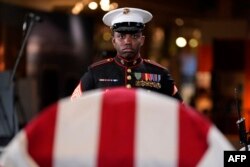 Marine Staff Sgt. Nayya Dobson-EL stands as part of the Guard of Honor at the flag-draped casket of former President Jimmy Carter as he lies in repose at the Jimmy Carter Presidential Library and Museum in Atlanta, Georgia, Jan. 4, 2025.