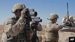 FILE - In this Nov. 1, 2018, photo released by the U.S. Army, soldiers surveil the area during a combined joint patrol in Manbij, Syria. 