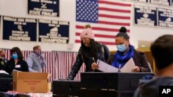 Women cast their ballots at a polling station in Windham, New Hampshire, Nov. 3, 2020. 