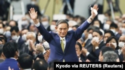 Yoshihide Suga gestures as he is elected as new head of the ruling party at the Liberal Democratic Party's (LDP) leadership election paving the way for him to replace Prime Minister Shinzo Abe, in Tokyo, Japan September 14, 2020. (Kyodo via REUTERS)