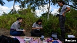 University of Havana professor Daniela Ventura speaks to students at Havana's Botanical Garden, in Havana, Cuba, February 9, 2024. (REUTERS/Norlys Perez)