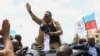 Tanzanian opposition leader Tundu Lissu waves to supporters after he returns from exile, as his vehicle moves through the streets of Dar es Salaam, Tanzania, Jan. 25, 2023. 