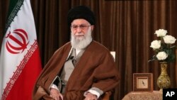 FILE - In this picture released by the official website of the office of the Iranian supreme leader, Supreme Leader Ayatollah Ali Khamenei sits prior to addressing the nation on state television in Tehran, Iran, March 22, 2020. 