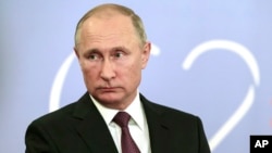 Russian President Vladimir Putin speaks to the media after the G-20 summit in Buenos Aires, Argentina, Dec. 1, 2018. Putin and Trump "said hi to each other," according to the Russian leader's spokesman, but didn't shake hands or otherwise speak.
