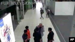 Kim Jong Nam, exiled half brother of North Korea's leader Kim Jong Un, points toward his face while talking to airport security and officials at Kuala Lumpur International Airport, Malaysia, in this image made Feb. 13, 2017. 