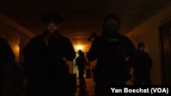 Ukrainian soldiers take shelter on a military post a few kilometers from the front line in eastern Ukraine, Feb. 19, 2022, in Novoluganske, Ukraine. (Yan Boechat/VOA)