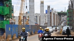 Motorists drive on Mombasa road, next to the ongoing construction site of the Nairobi Expressway, undertaken by the Chinese contractor China Road and Bridge Corporation (CRBC), in Nairobi, Kenya, July 12, 2021.