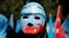 Seorang pengunjuk rasa Uighur mengenakan topeng dalam unjuk rasa di depan Konsulat China di Istanbul, Turki, 1 Oktober 2019.