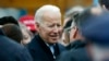 FILE - Former vice president Joe Biden,who just announced his candidacy for the 2020 elections, talks with officials after speaking at a rally in support of striking workers in Boston, April 18, 2019.