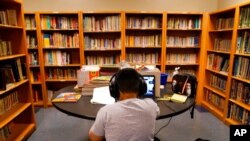 FILE - In this Aug. 26, 2020, photo, a Los Angeles Unified School District student attends an online class at Boys & Girls Club of Hollywood in Los Angeles.