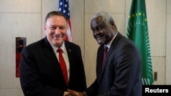 U.S. Secretary of State Mike Pompeo shakes hands with African Union Commission Chairperson Moussa Faki Mahamat at the African Union Headquarters in Addis Ababa, Ethiopia, Feb. 18, 2020. 